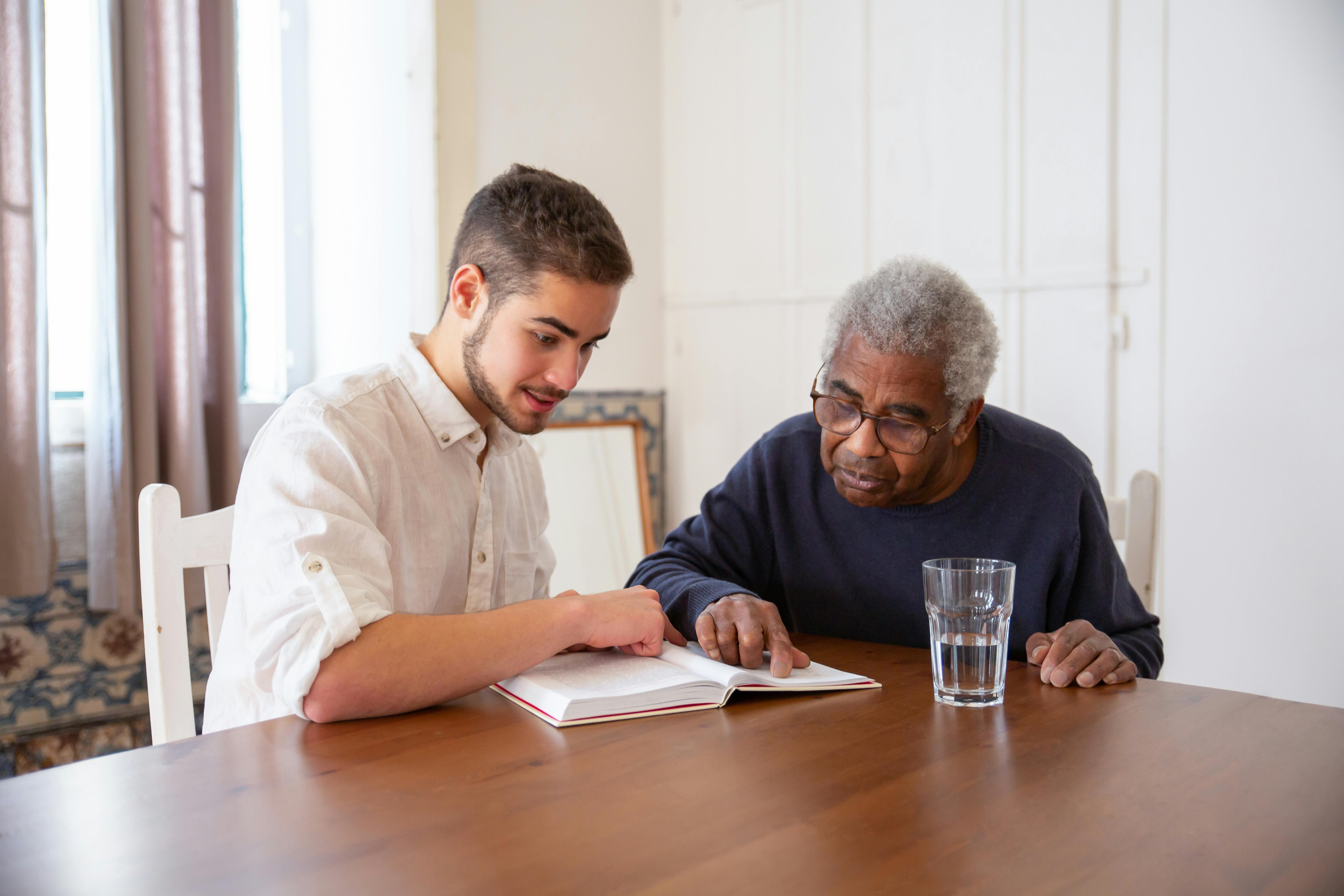 Caring sitter checking in with a senior